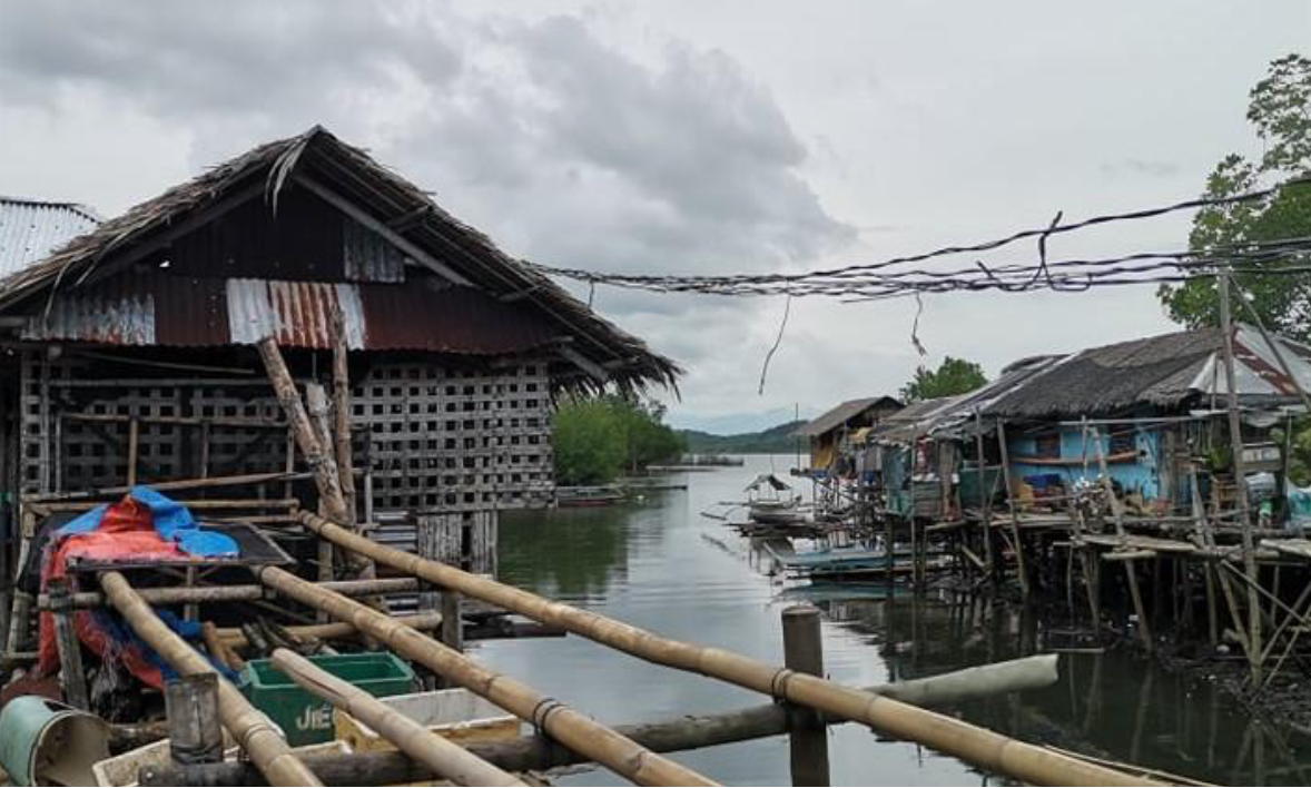 Housing units made of shanties rise above the waterline in one of the barangays in the Municipality of Batan.